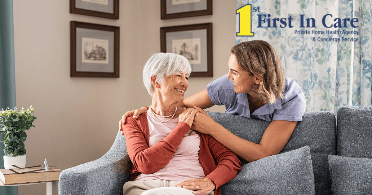 Smiling caregiver with hand over the shoulder of a happy elderly woman who is receiving home care services.