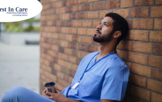 An exhausted professional caregiver takes a break outside.