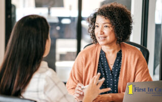 A woman interviews another woman for a caregiver job position.