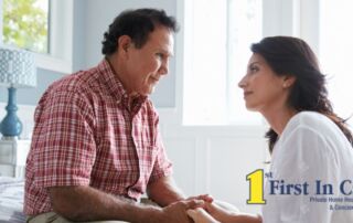 A daughter who is caregiving for her dad who has Alzheimer’s disease, lovingly holds his hands.