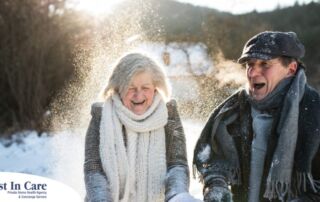 As a result of good winter safety practices, an elderly couple can enjoy time outside in the snow.