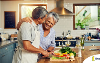 A senior couple enjoys cooking a healthy meal together, representing National Nutrition Month.