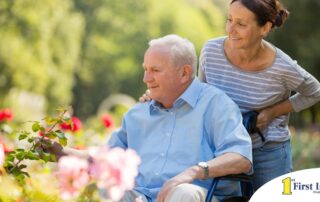 A caregiver takes a senior outside to visit a garden, highlighting one idea for senior activities.