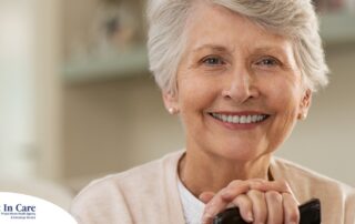 An older woman with healthy teeth smiles, representing good dental hygiene.