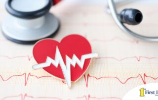 A heart symbol with an electrocardiogram line, an electrocardiogram sheet, and a stethoscope represents heart health.